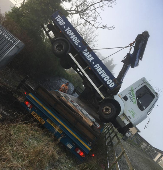 scrap truck loaded onto recovery vehicle